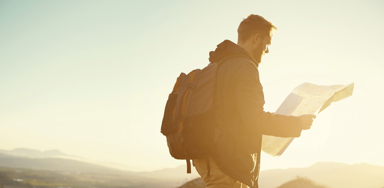 hiker looking at map in the sun