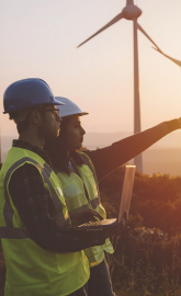 Electrical engineers on a field of wind turbines