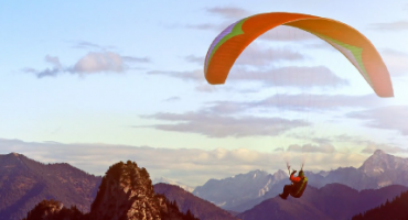 man gliding on parachute