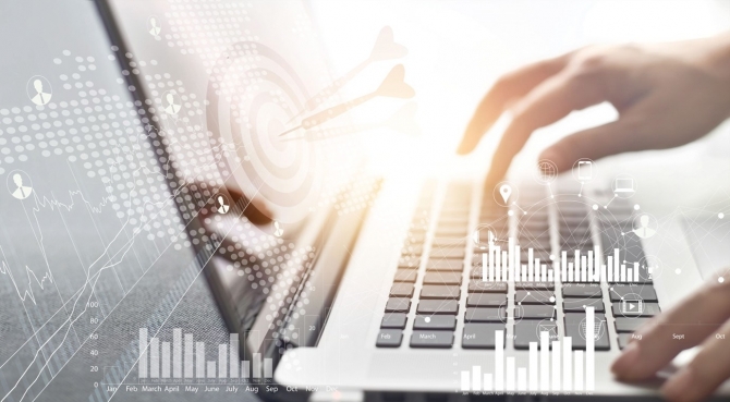 Top line growth in the digital age: Hands typing on laptop overlaid with charts and images