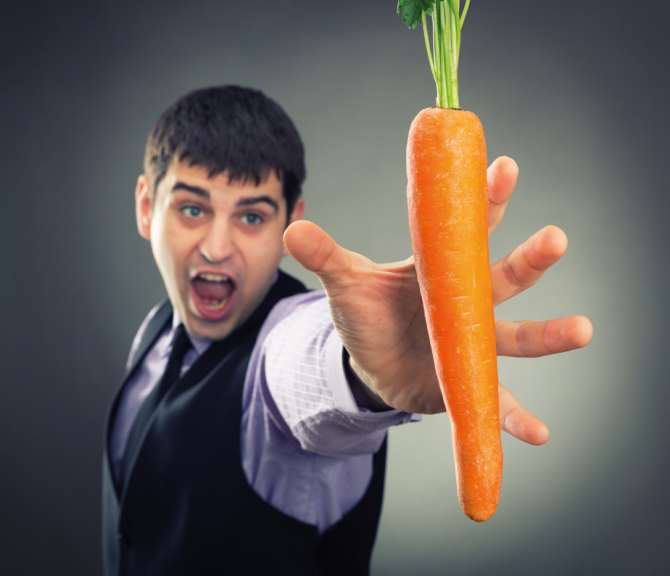 Man aiming for a carrot