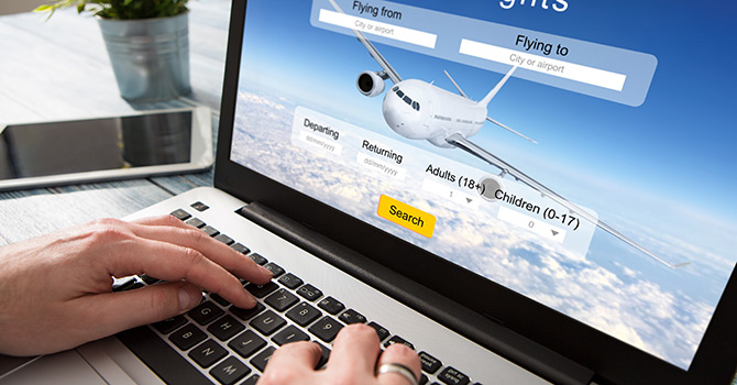Booking flight on laptop