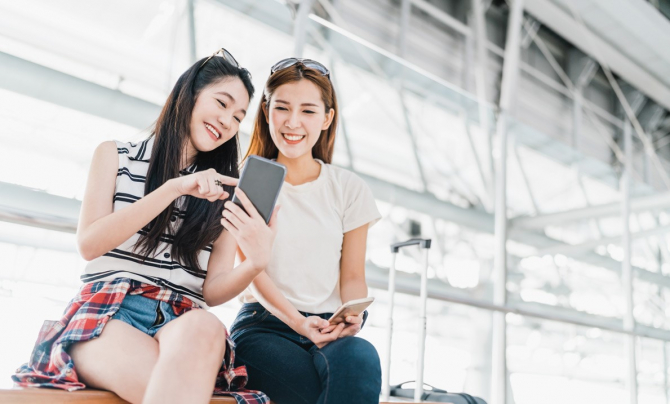 two woman sitting in airport