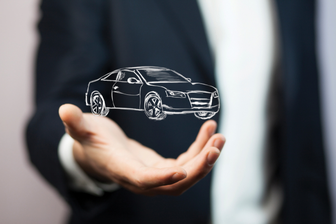 Man holding hologramic drawing of a car