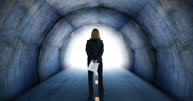 Businesswoman standing in a tunnel