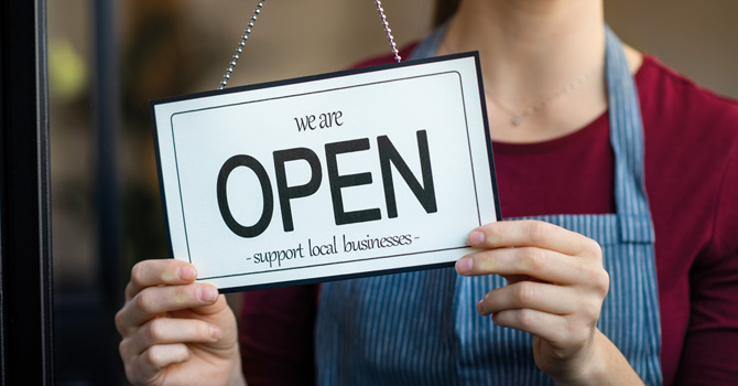 shop owner with open business card
