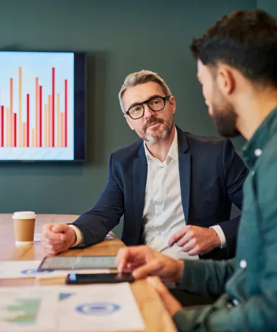 two men discussing commercial performance