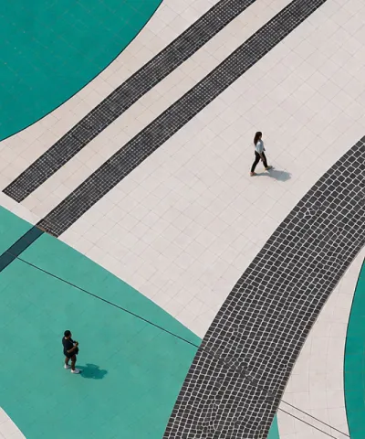 people on top of teal swirls