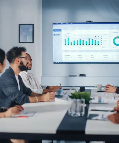 employees discussing blue chart