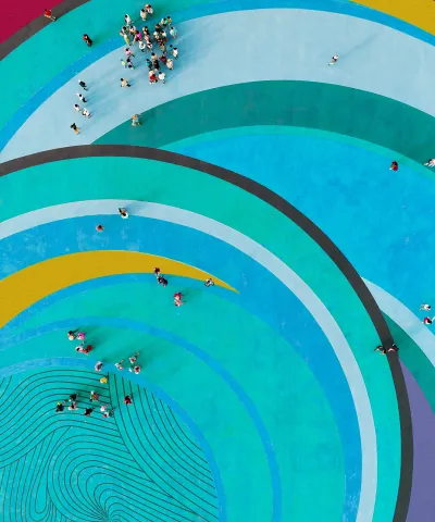 aerial view of people gathered standing on swirls of colour