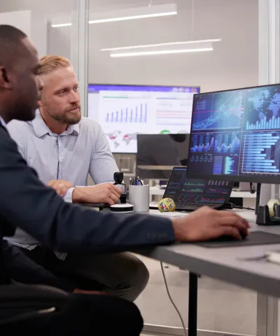 two people sitting in front of a computer
