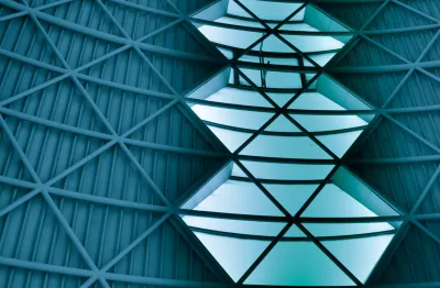 Green transition: An image of open sky seen through gaps in a steel roof