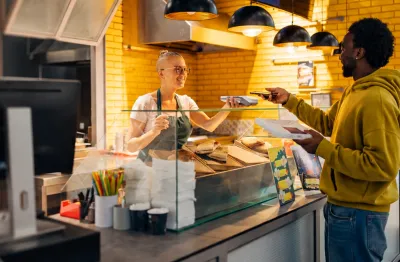 man paying on payments machine