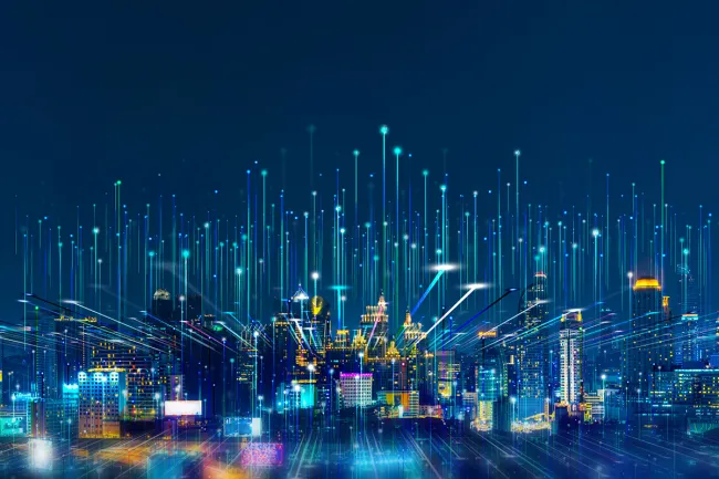 Digitally generated image of city with neon lines connecting the buildings and the sky