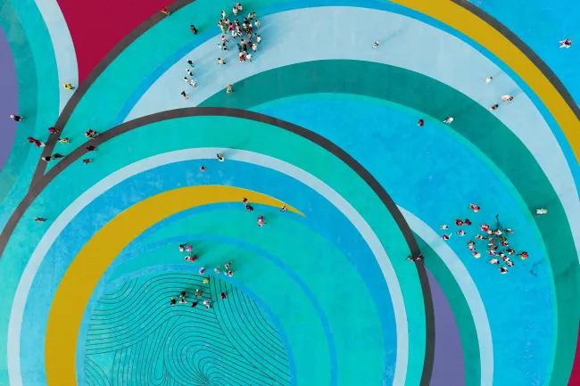 aerial view of people gathered standing on swirls of colour