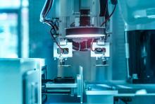 Industrial machinery with shining light on blue background