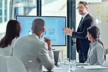 man talking at the meeting in front of the people