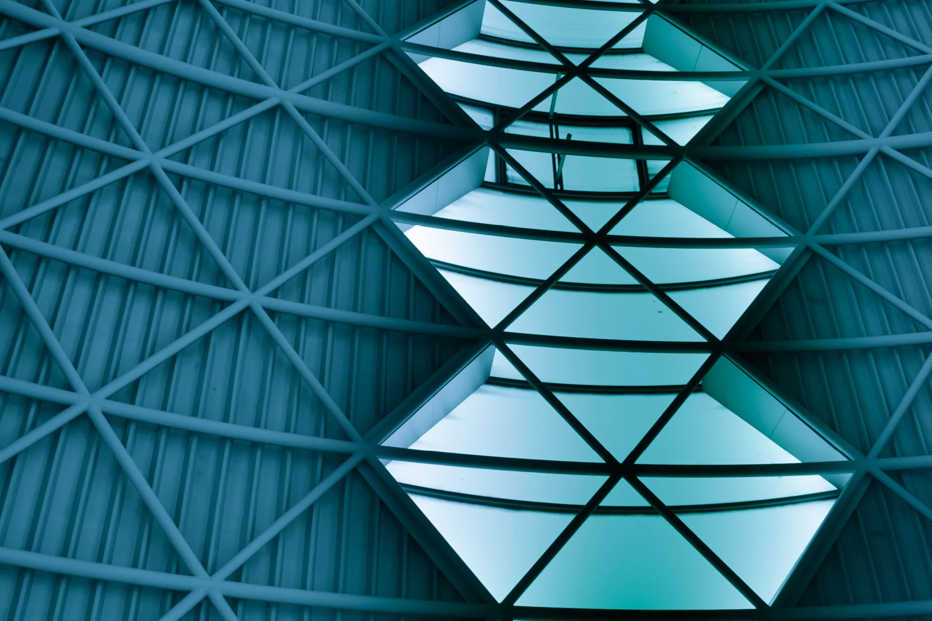 Green transition: An image of open sky seen through gaps in a steel roof