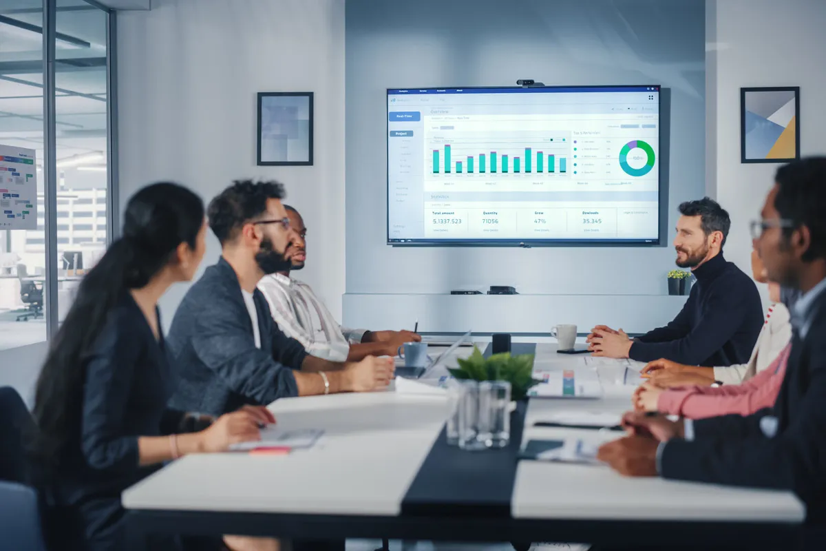 employees discussing blue chart