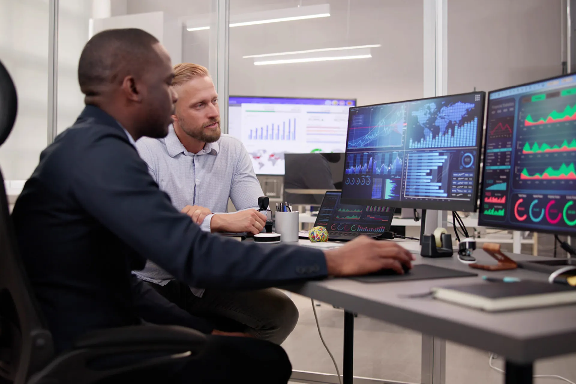 two people sitting in front of a computer
